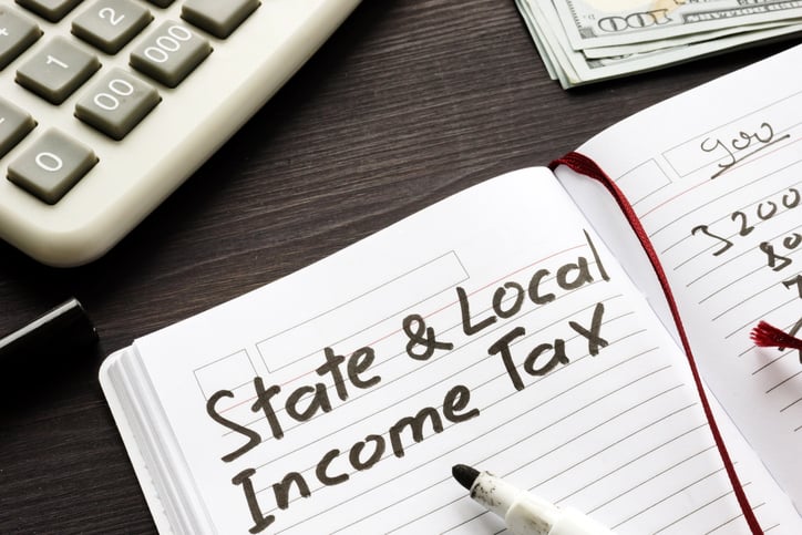 State and local income tax written in a note for a person reviewing the SALT Deduction Cap