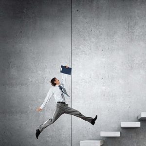 A businessman holding a clipboard is jumping up a flight of stairs