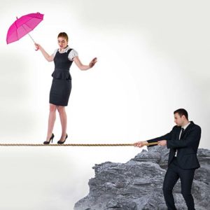 Woman accountant holding a pink umbrella walking on a rope a business accountant is holding